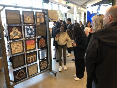 People looking at a display of 12 patterns