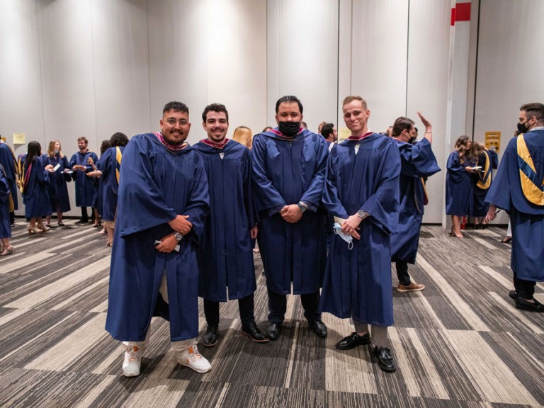 Four Humber graduates posing