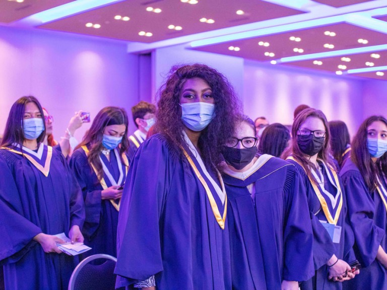 Humber graduates wearing face masks looking at the photographer