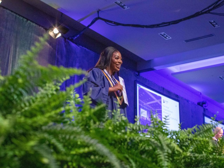 Graduate smiling on stage