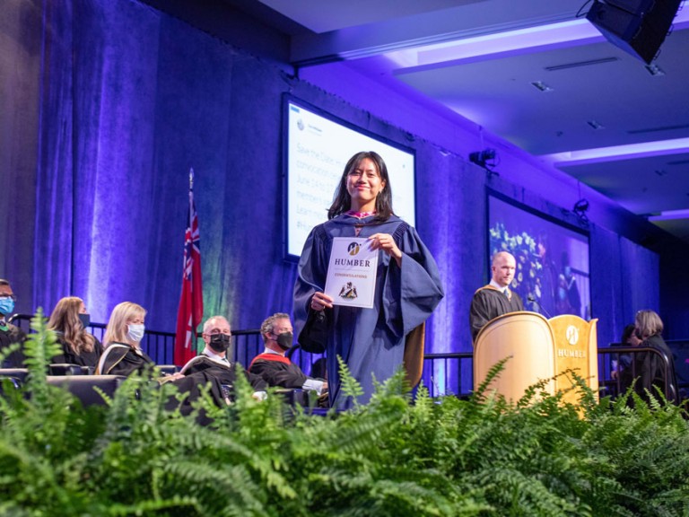 Humber graduate crossing the stage with their diploma