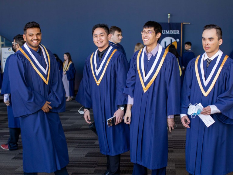 Four Humber graduates smiling