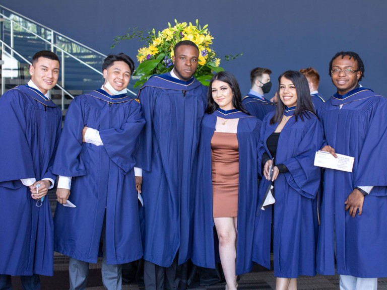 Group of six graduates smiling