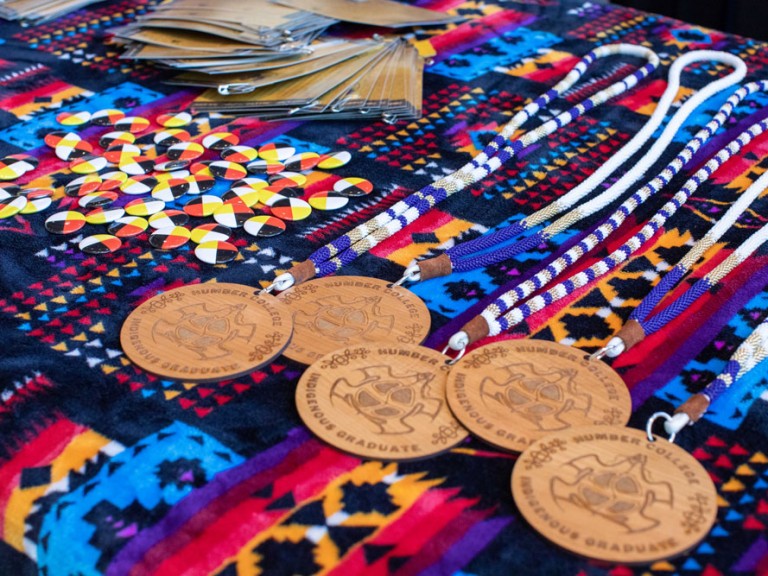 Humber Indigenous graduate badges on a table
