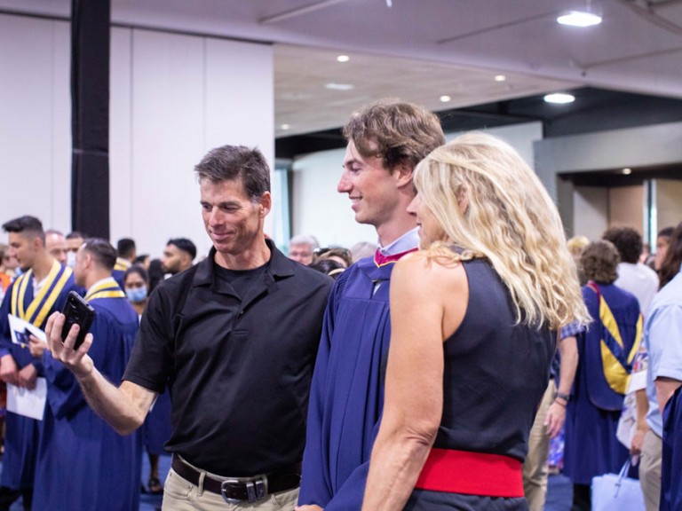 Humber graduate takes photos with their parents