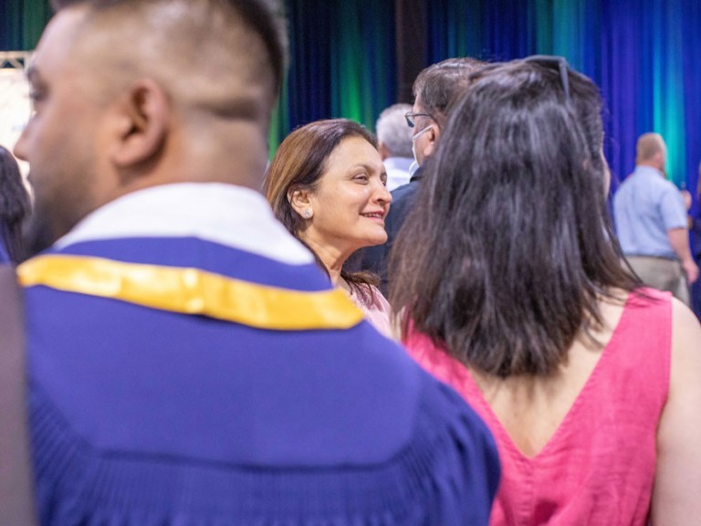 Mixed crowd of ceremony guests and graduates