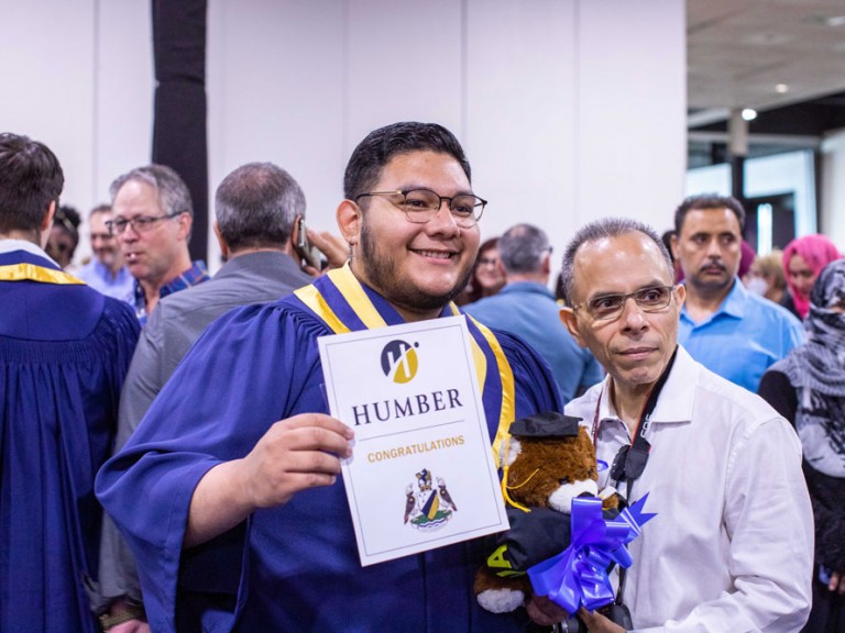 Humber graduate posing with another person