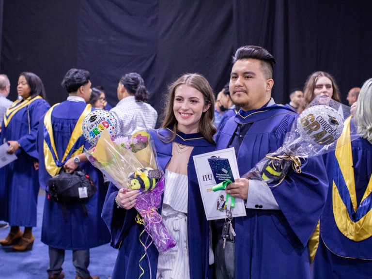 Two graduates posing for a photo