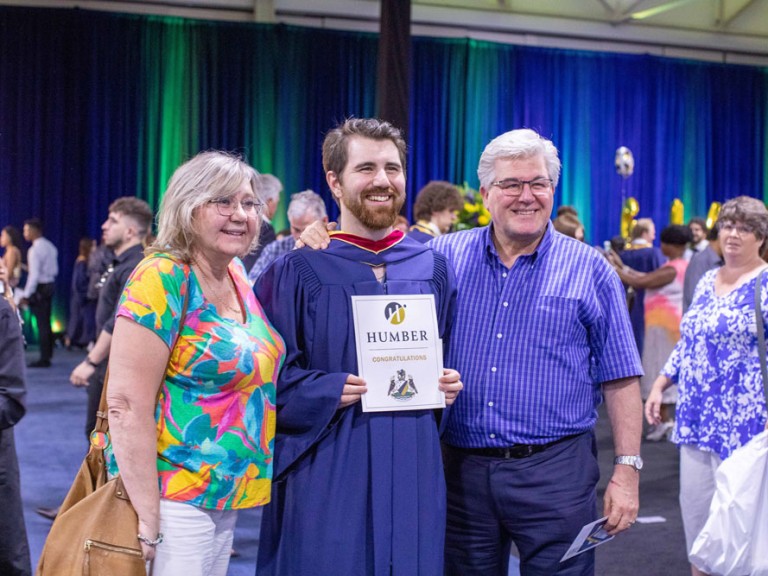 Humber graduate posing for a photo with family
