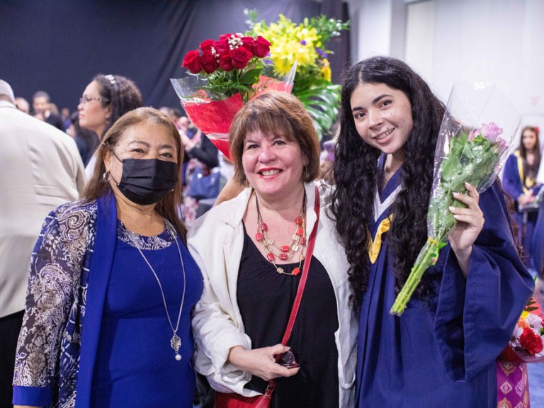 Humber graduate posing with two ceremony guests