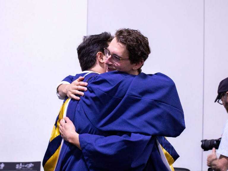 Two Humber graduates hugging
