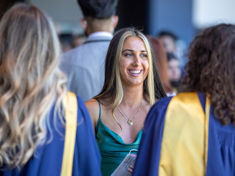 Humber graduate smiling with other graduates