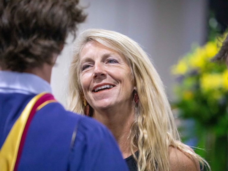 Ceremony guest smiling at a graduate