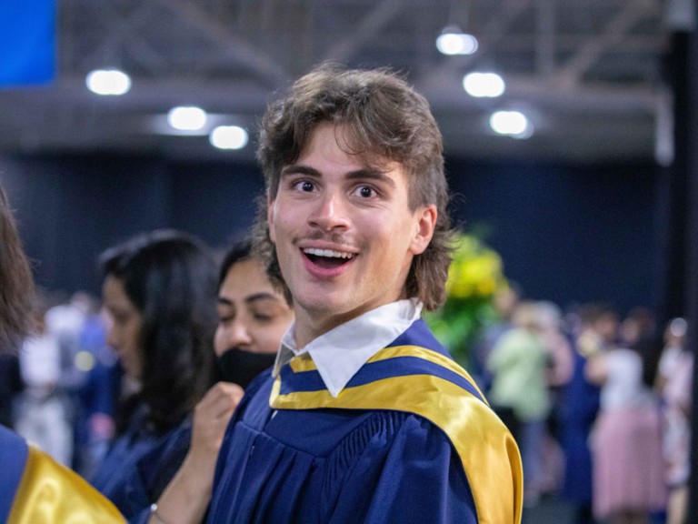 Graduate smiling in surprise