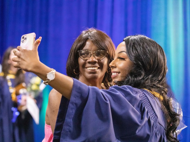 Graduate taking a selfie with someone