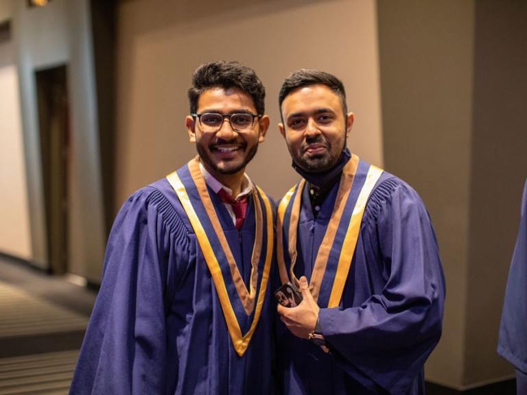Two Graduates at Humber Graduation smiling at Camera