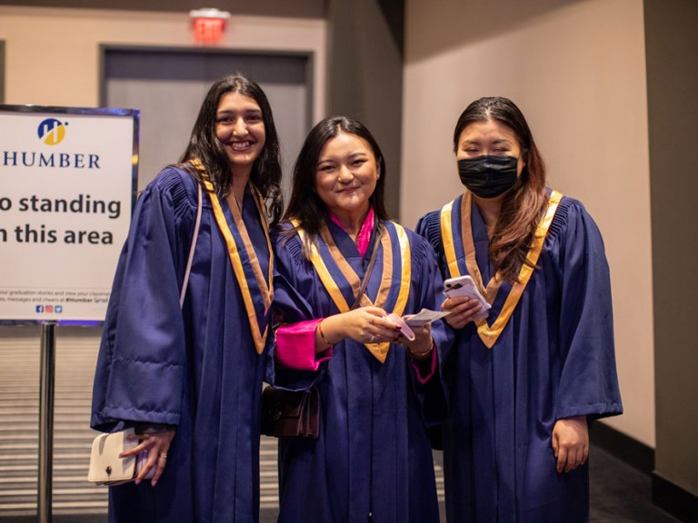 Group of New Graduates smiling at Camera