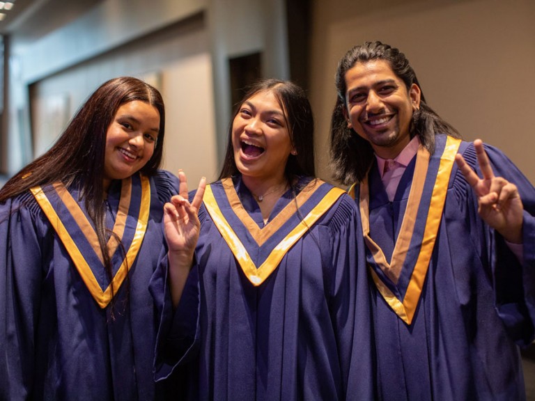 Three Humber Graduates smiling and laughing at Camera