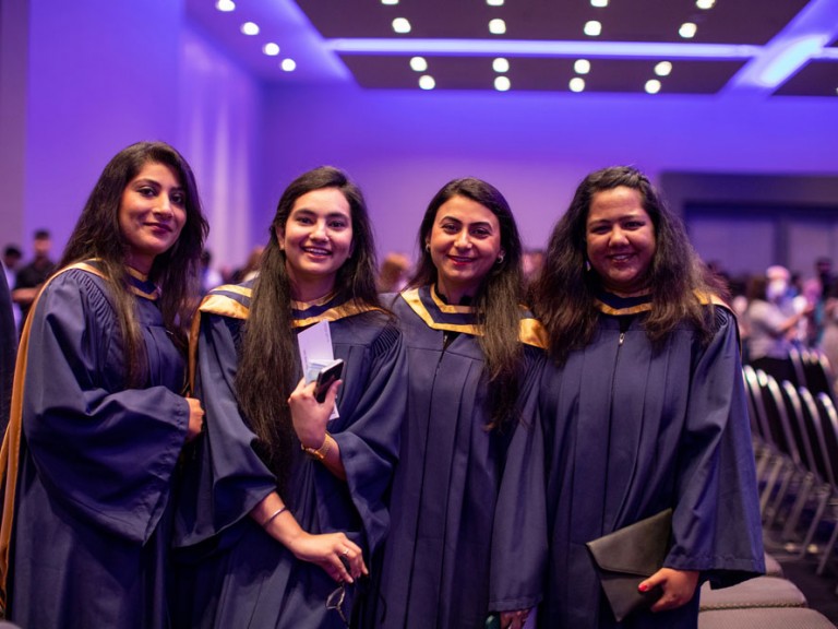 Group of four Humber Graduates smiling at camera