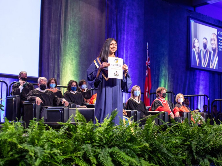 New Humber Graduate smiling on stage