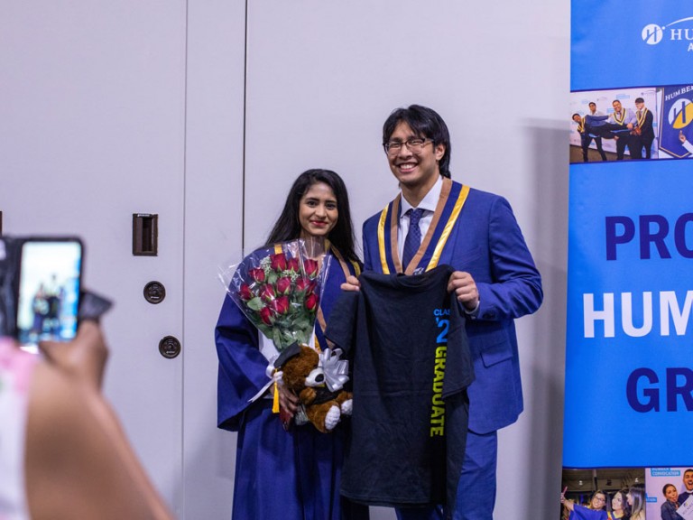 Two Humber graduates holding t-shirt