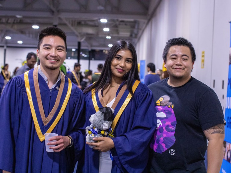 Two Humber graduates Smiling with friend