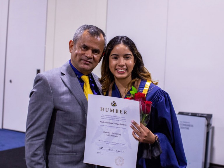 Humber Graduate with person holding their Diploma
