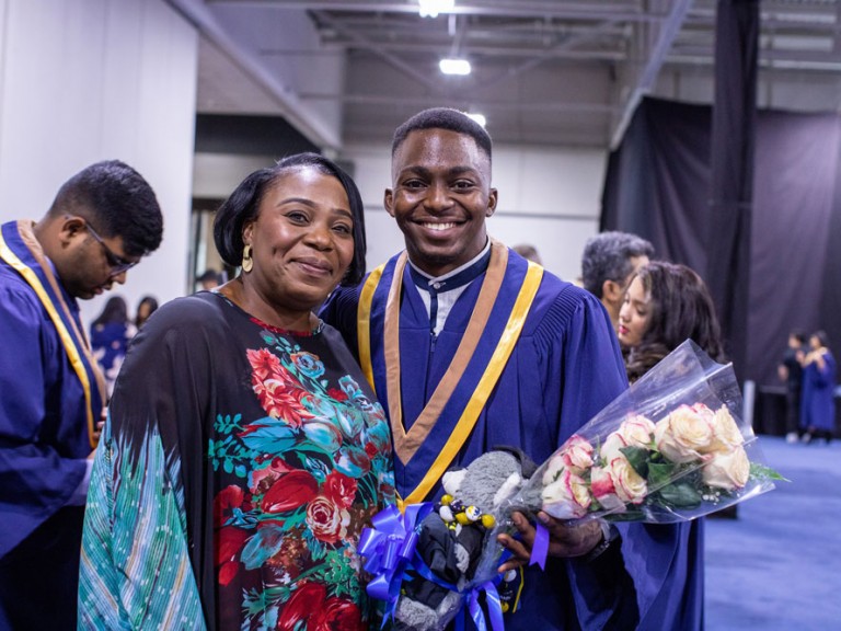 Humber Graduate with Parent holding flowers