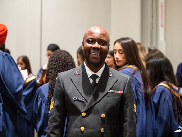 Person in uniform jacket smiling at camera