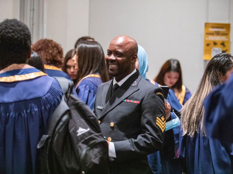 Person in uniform jacket smiling