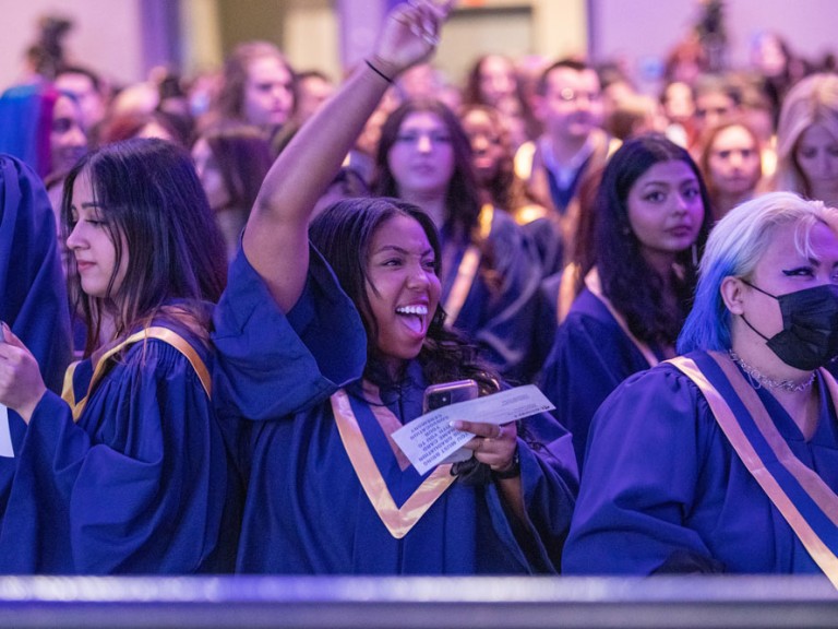 Person cheering at commencement