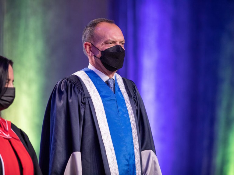 Former Humber President Chris Whitaker standing on Graduation stage