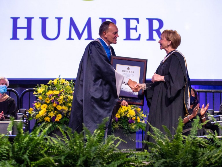 Chris Whitaker shaking hands with another person