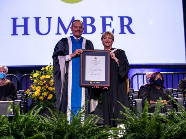 Chris Whitaker holding framed document