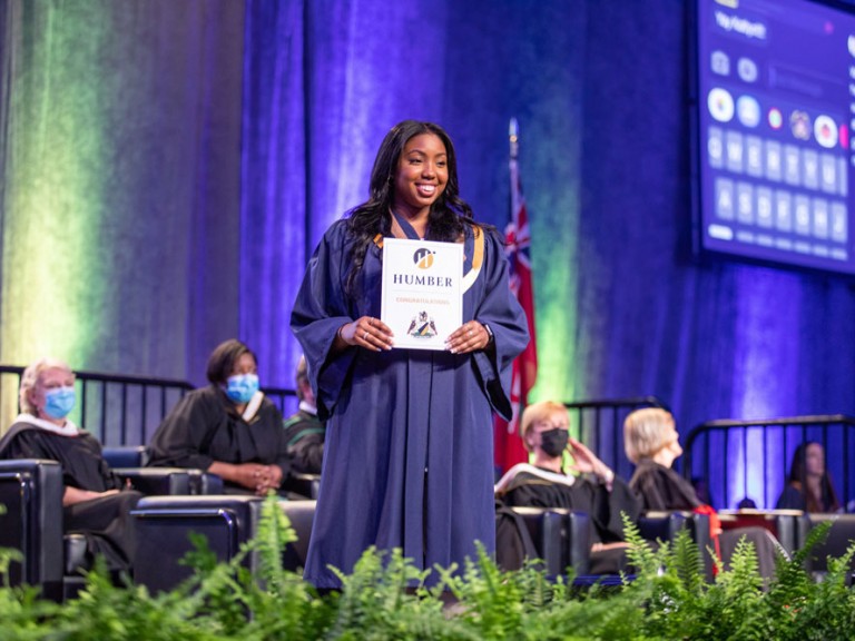 graduate on stage with diploma