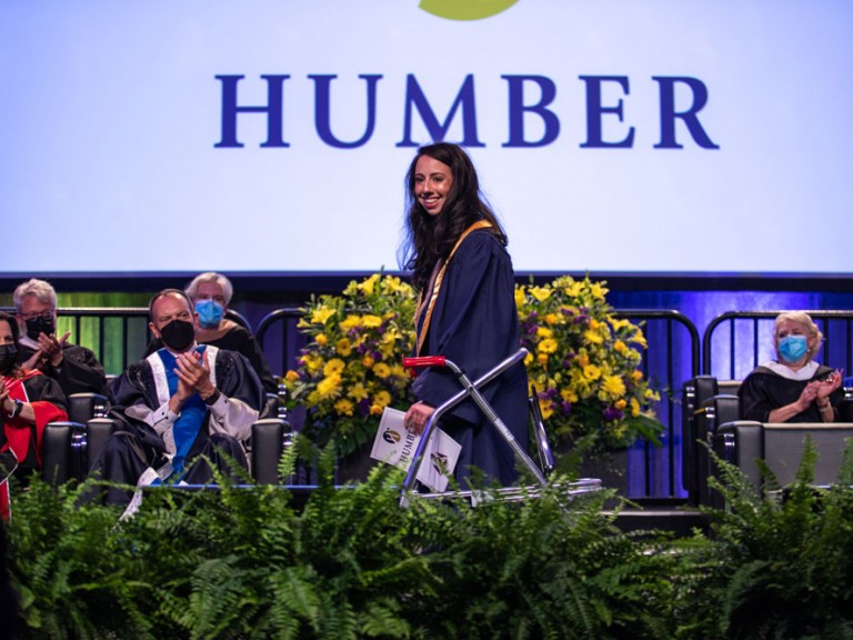 graduate crossing stage smiling