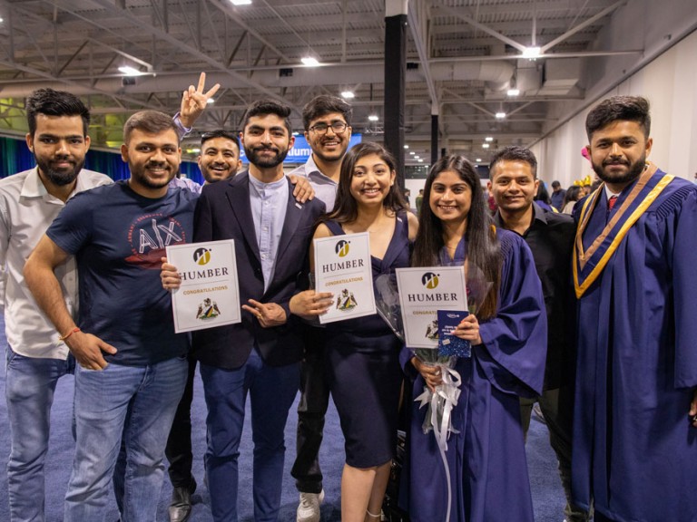 group of people smile and pose for camera