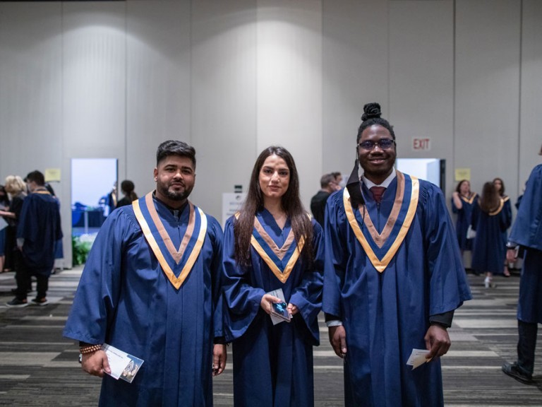 three graduates posing for photo