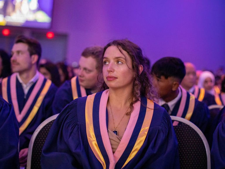 Humber Graduate listening to speaker on stage