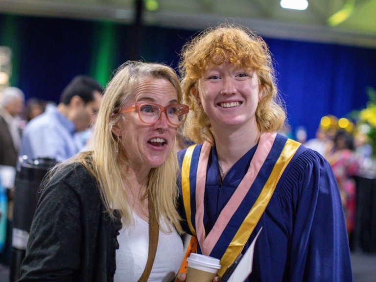 Graduate smiling with family member