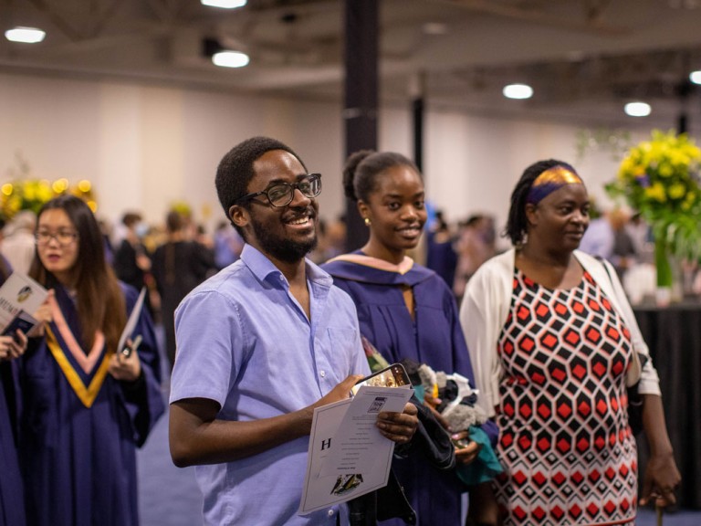 graduate with ceremony guests among the crowd