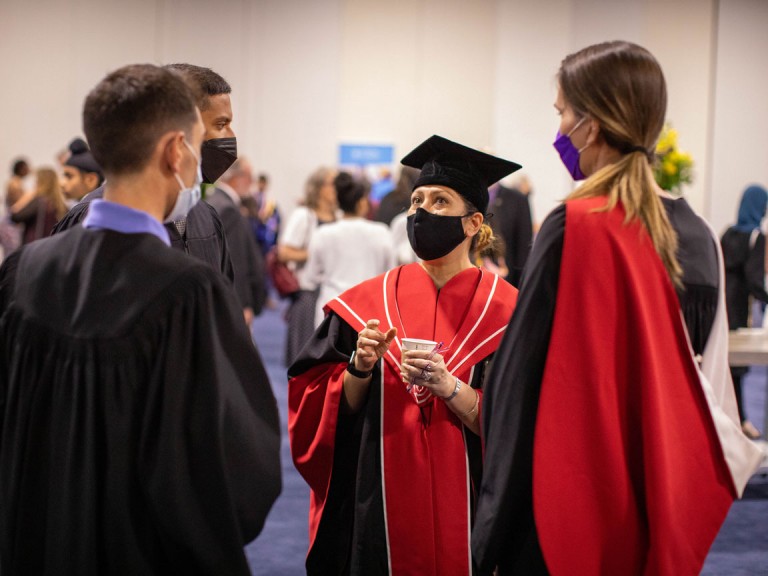 Humber faculty wearing masks talk amongst crowd