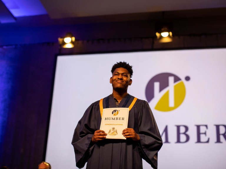 Graduate smiles on stage