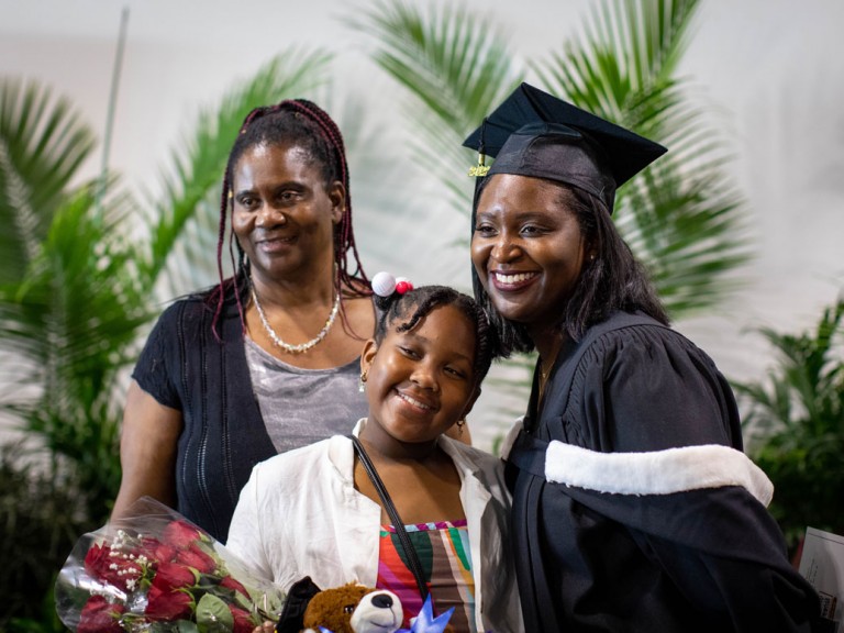 graduate with roses with family
