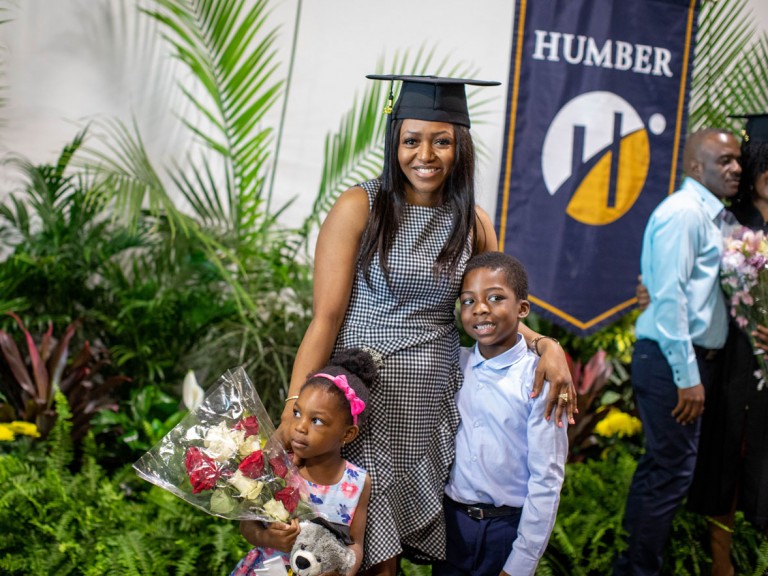 Humber graduate posing with children