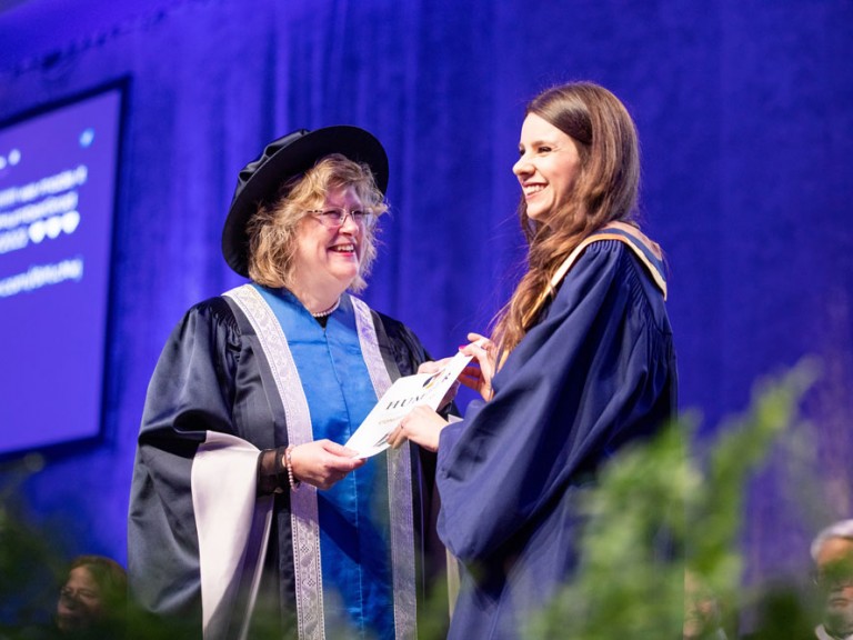 Ann Marie Vaughn presenting certificate to graduate