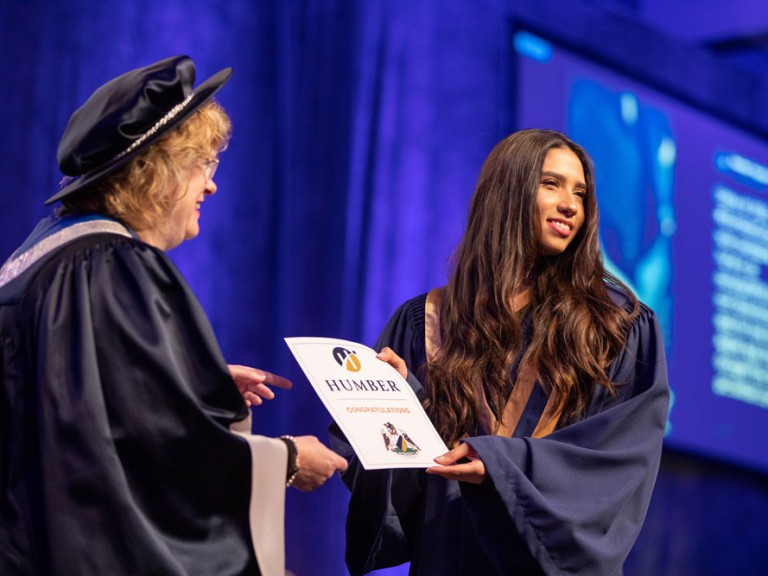 Graduate receiving certificate from Humber president