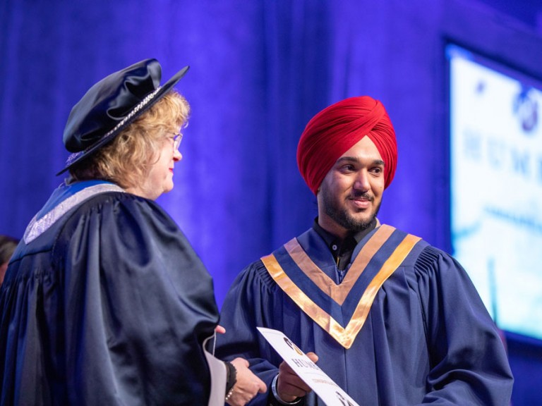 Graduate receiving certificate from Humber president