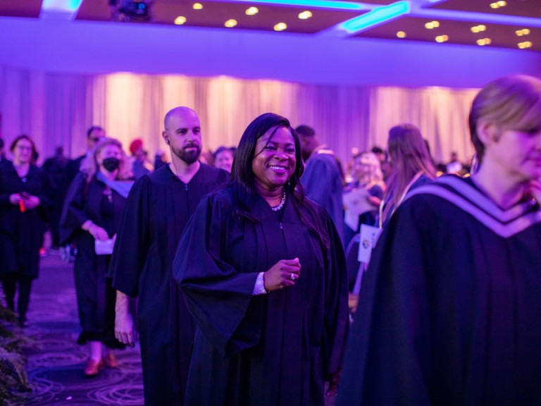 Faculty members walking in line