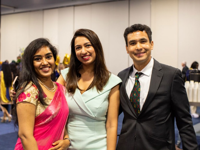 Three people smiling for photo